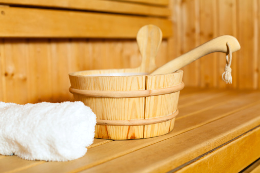 Close-up of towel, bucket and ladle in sauna.