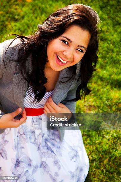 Joyful Latina Smiles At Camera From Low Angle Stock Photo - Download Image Now - 16-17 Years, Adolescence, Adult