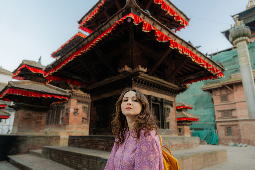 Cheerful woman exploring  Durbar square in Nepal