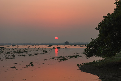 Beautiful sunset over the water in rural area of Sylhet division, Bangladesh
