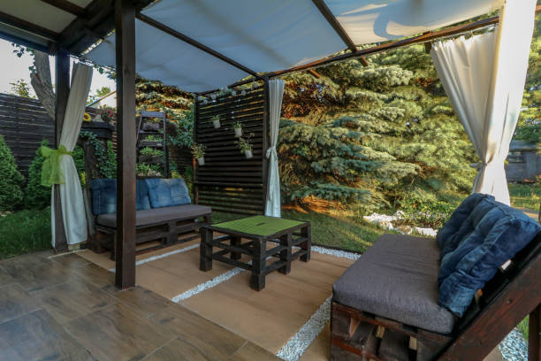 istock Laying terrace tiles in a gazebo on a recreation plot 1754574403