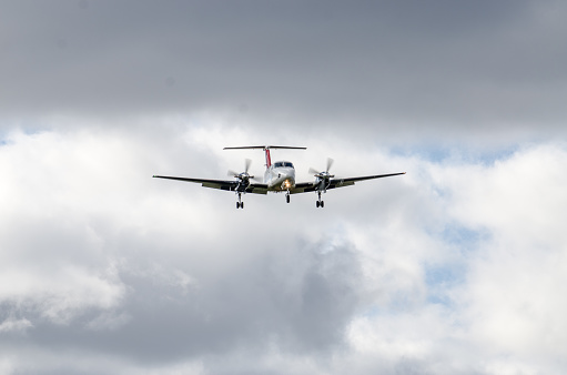 Small propeller airplane approaching the Quebec city airport during autumn day.