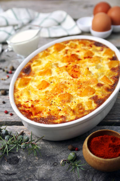 istock French cuisine. Vegetable pumpkin clafoutis in ceramic bakeware, smoked paprika dressing, eggs and cream 1754576630