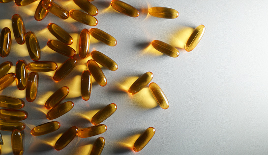 Medicine in gelatin capsules on a white background