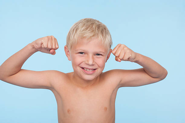 80+ Boy Flexing Muscles At The Beach Stock Photos, Pictures & Royalty ...