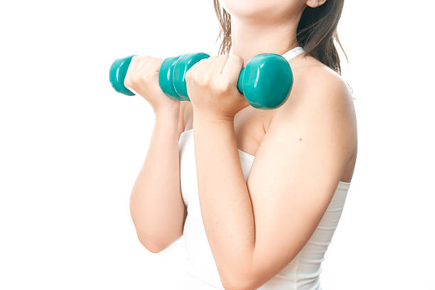 istock Young woman doing exercises with dumbbells 175460205