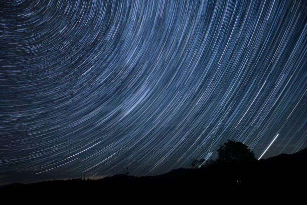 istock Wide panoramic view, created from multiple images, showing earth’s rotation and a beautiful startrail from the Slovenian wild highlands, during a summer night in august 1754603229