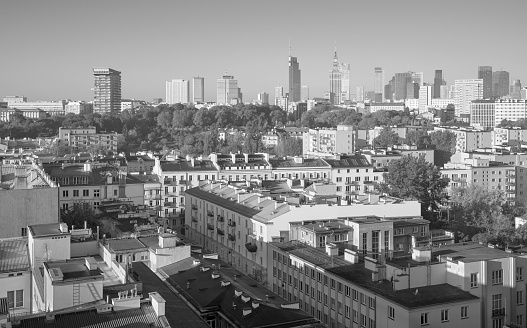 Black and white photo of Warsaw skyline on a cloudless day, Poland.