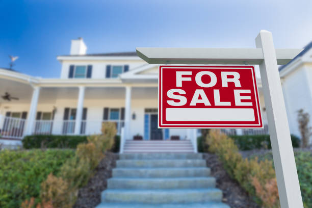 For Sale Real Estate Sign in Front of New House. stock photo