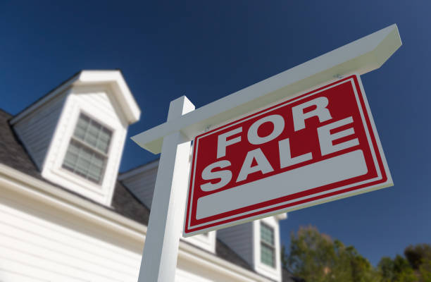 For Sale Real Estate Sign in Front of New House. stock photo