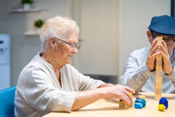 istock Woman and man in a nursing home playing skill games 1754611050