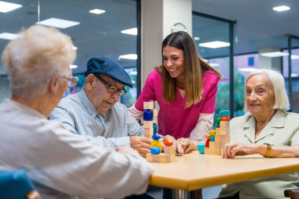 istock Nurse encouraging elder people playing skill games in a nursing home 1754620197
