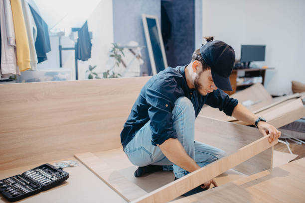 istock man assembling furniture wooden cabinet at home 1754627708