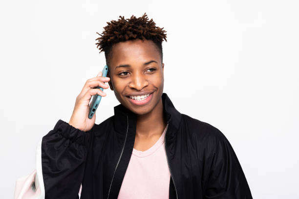 istock African american dark skinned man with cell phoone over white background in studio isolated smiling loking into distance talking by phone while shooting process 1754628100