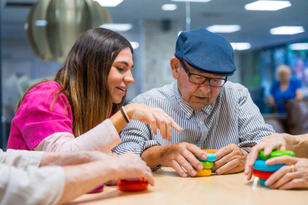 istock Nurse advising a elder man playing skill games 1754628223