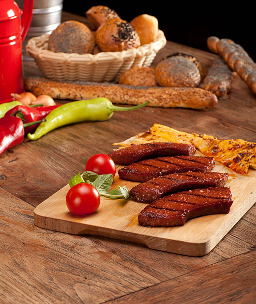 Traditional Turkish food on a wooden platter Traditounal Turkish food Sucuk (Sausage) turkish sausage stock pictures, royalty-free photos & images