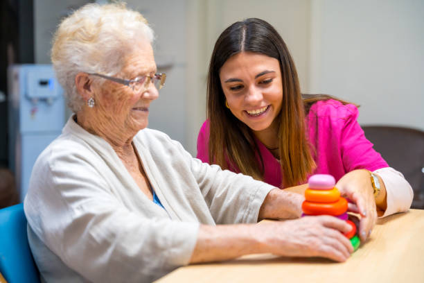 Cute nurse helping a woman to play board skill game
