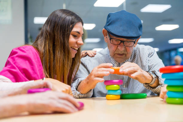 istock Man and nurse playing board game in a nursing home 1754629388