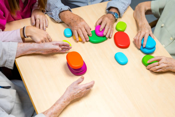 istock Hands of aged people playing board game indoors 1754629389