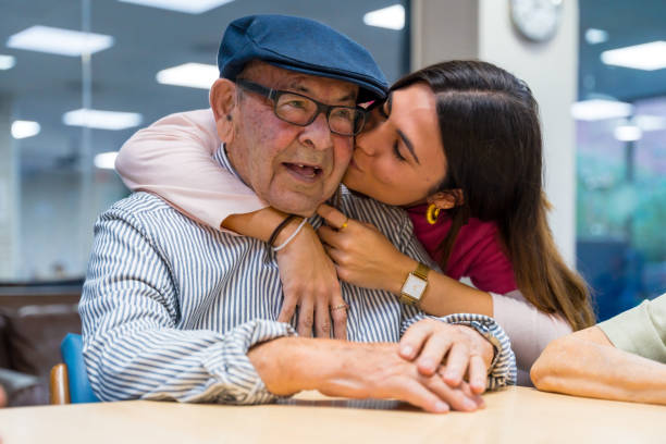 istock Nurse kissing and embracing a elder man in a geriatric 1754629696