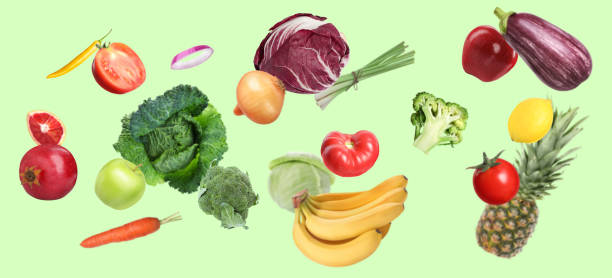 istock Many fresh vegetables and fruits falling on light green background 1754649626
