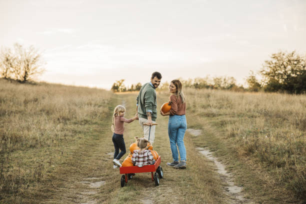 istock Young family at pumpkin patch 1754649669