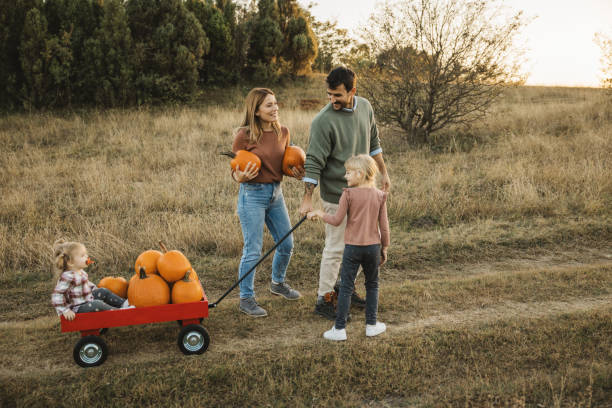 istock Young family at pumpkin patch 1754649673