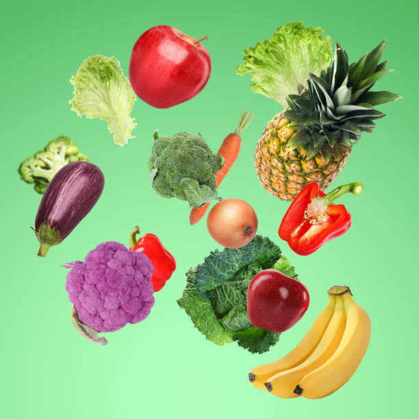 istock Many fresh vegetables and fruits falling on light green background 1754650200
