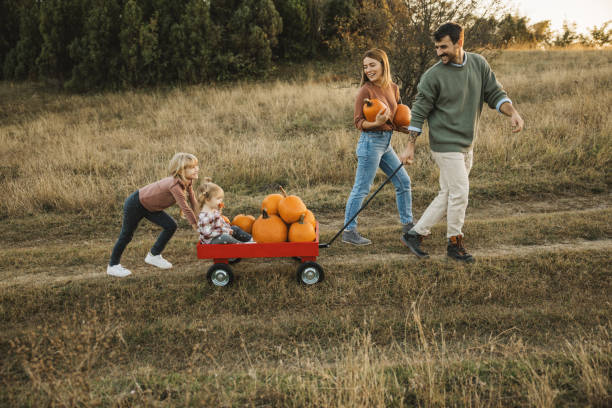 istock Young family at pumpkin patch 1754650212