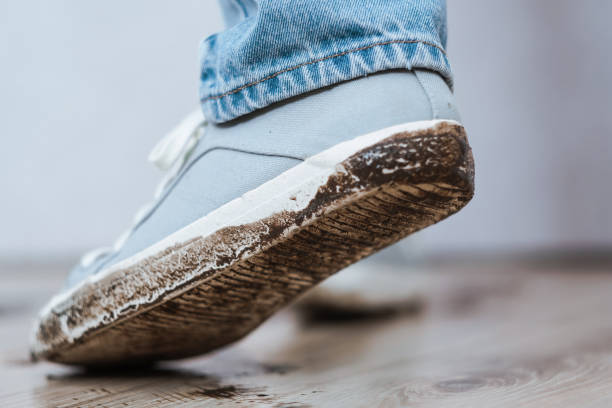 istock Mud footprint on white shoes and floor 1754650275