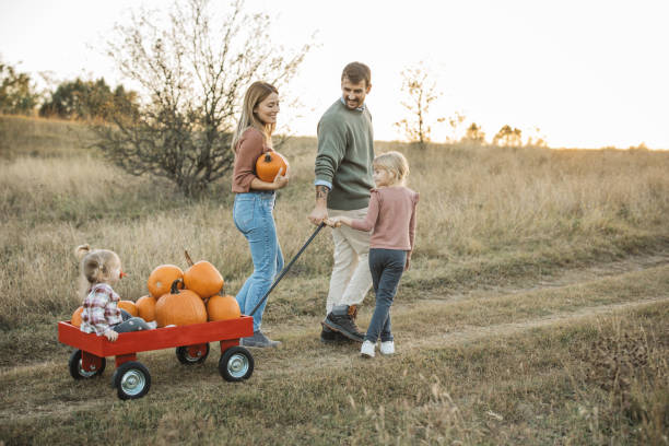 istock Young family at pumpkin patch 1754652571