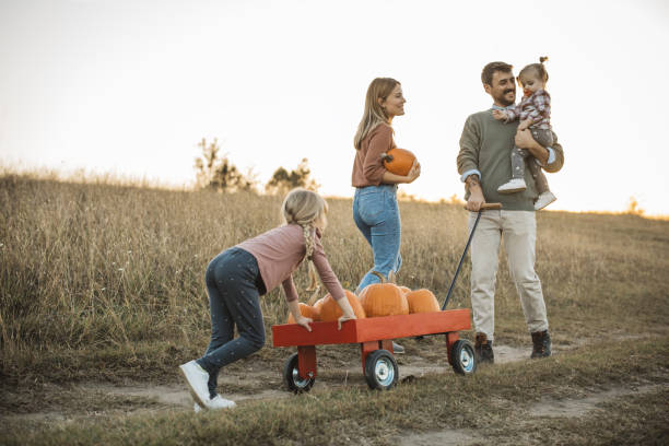 istock Young family at pumpkin patch 1754652573