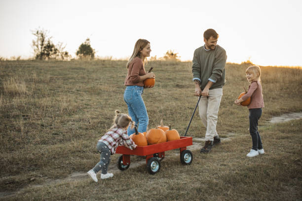 istock Young family at pumpkin patch 1754653097