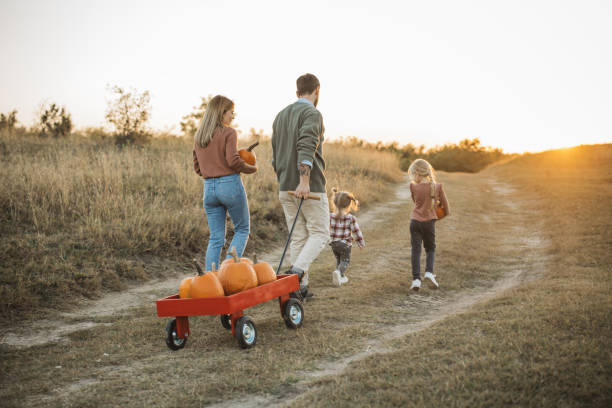 istock Young family at pumpkin patch 1754653099