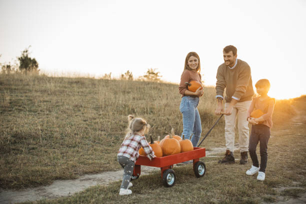 istock Young family at pumpkin patch 1754653100