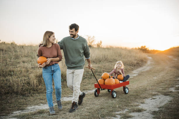 istock Young family at pumpkin patch 1754653135