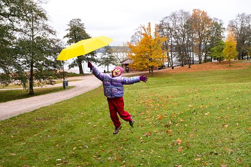 Caucasian girl walks in the park in autumn, park in Finland