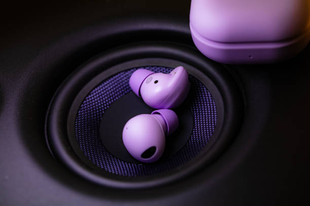 istock wireless earpone buds on speakers background 1754685702