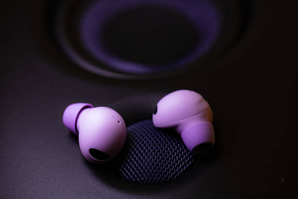 istock wireless earpone buds on speakers background 1754686273