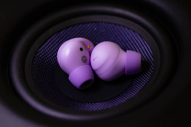 istock wireless earpone buds on speakers background 1754686280