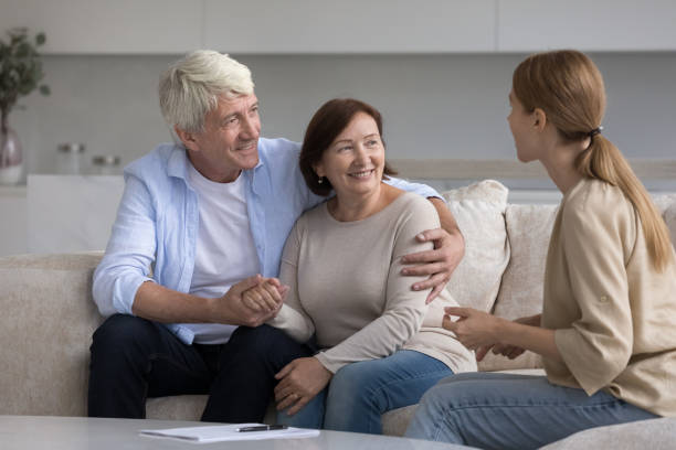 istock Consultant visiting senior couple at home, explaining agreement 1754693478