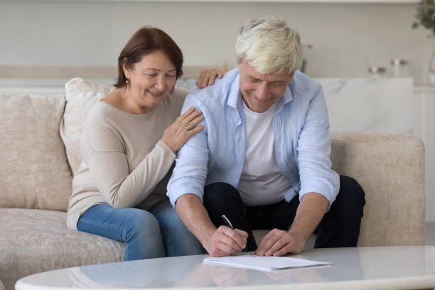 istock Positive senior retired husband and wife signing document 1754693915