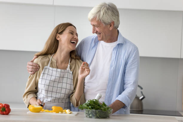 istock Cheerful daughter and mature elder father enjoying cooking 1754694003