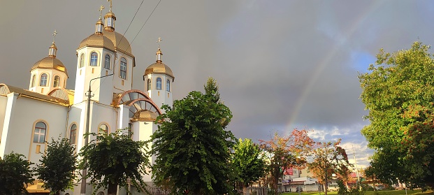 Church against the background of the rainbow