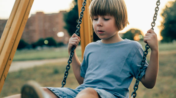 istock a child plays with the swing on the playground 1754702885
