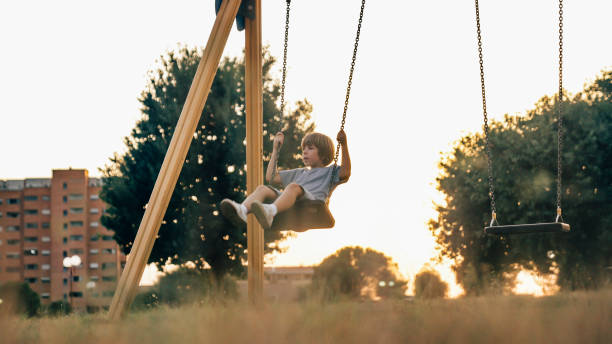 istock a child plays with the swing on the playground 1754702893