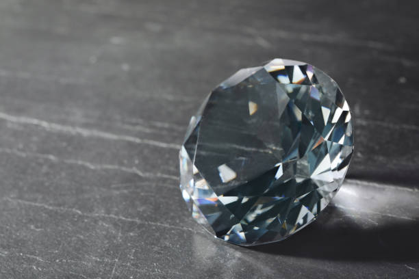 istock Beautiful dazzling diamond on black textured background, closeup. Space for text 1754716503
