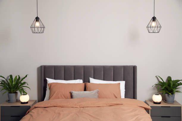 istock Stylish bedroom interior with comfortable bed and green houseplants 1754717794