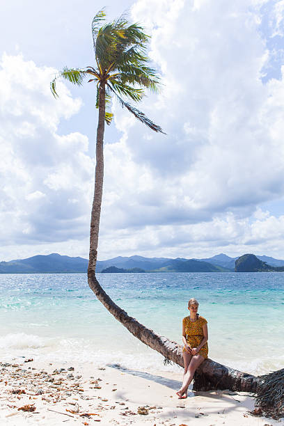 istock Woman sitting on a palm 175473075