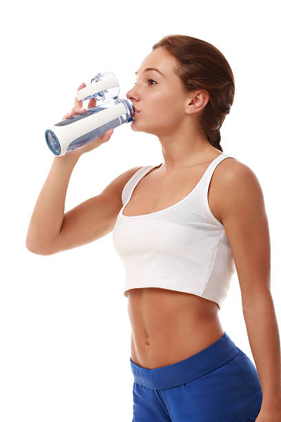 istock Attractive fitness female model drinking water 175473389